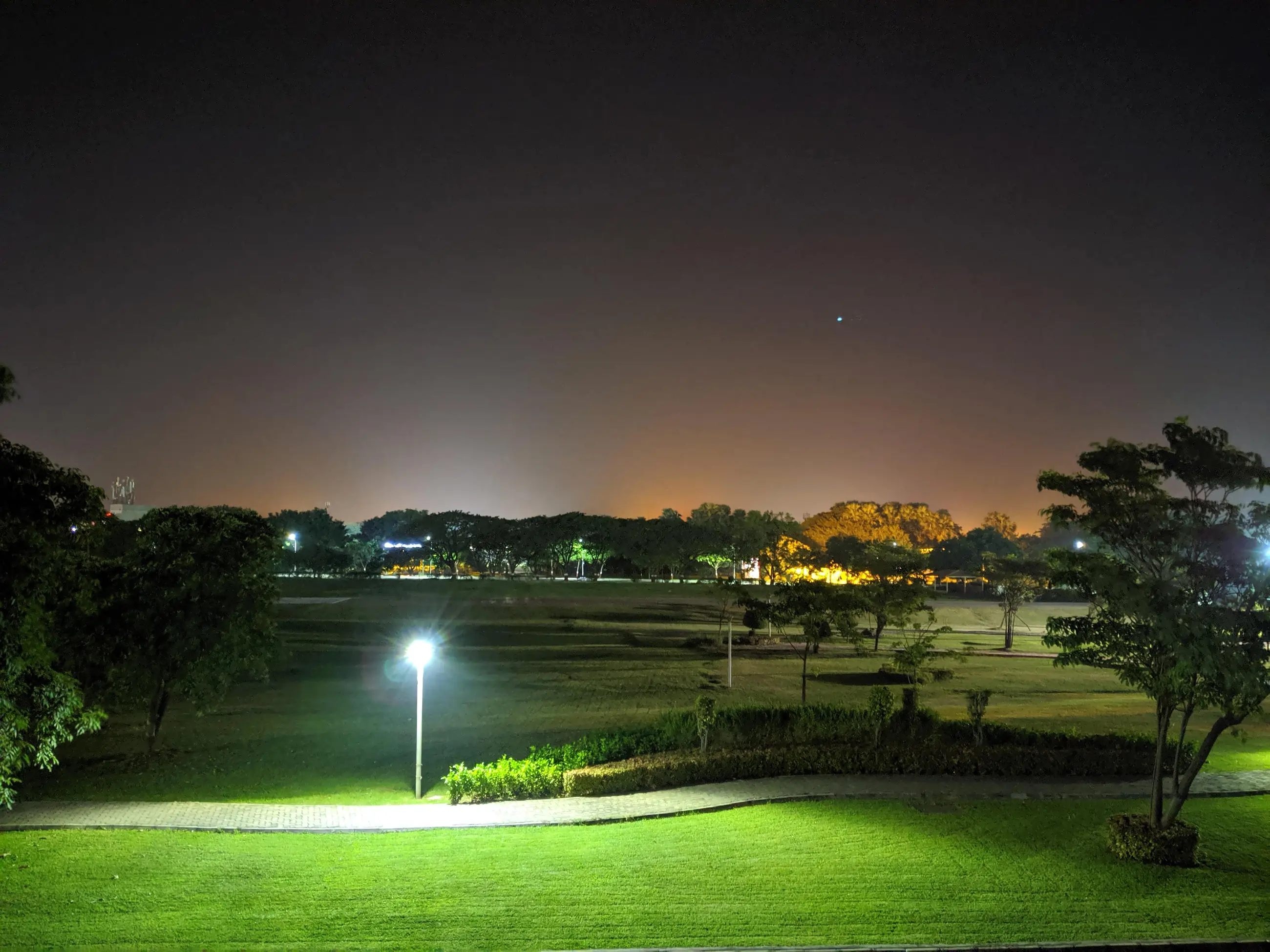 Serene green fields at night in Surat