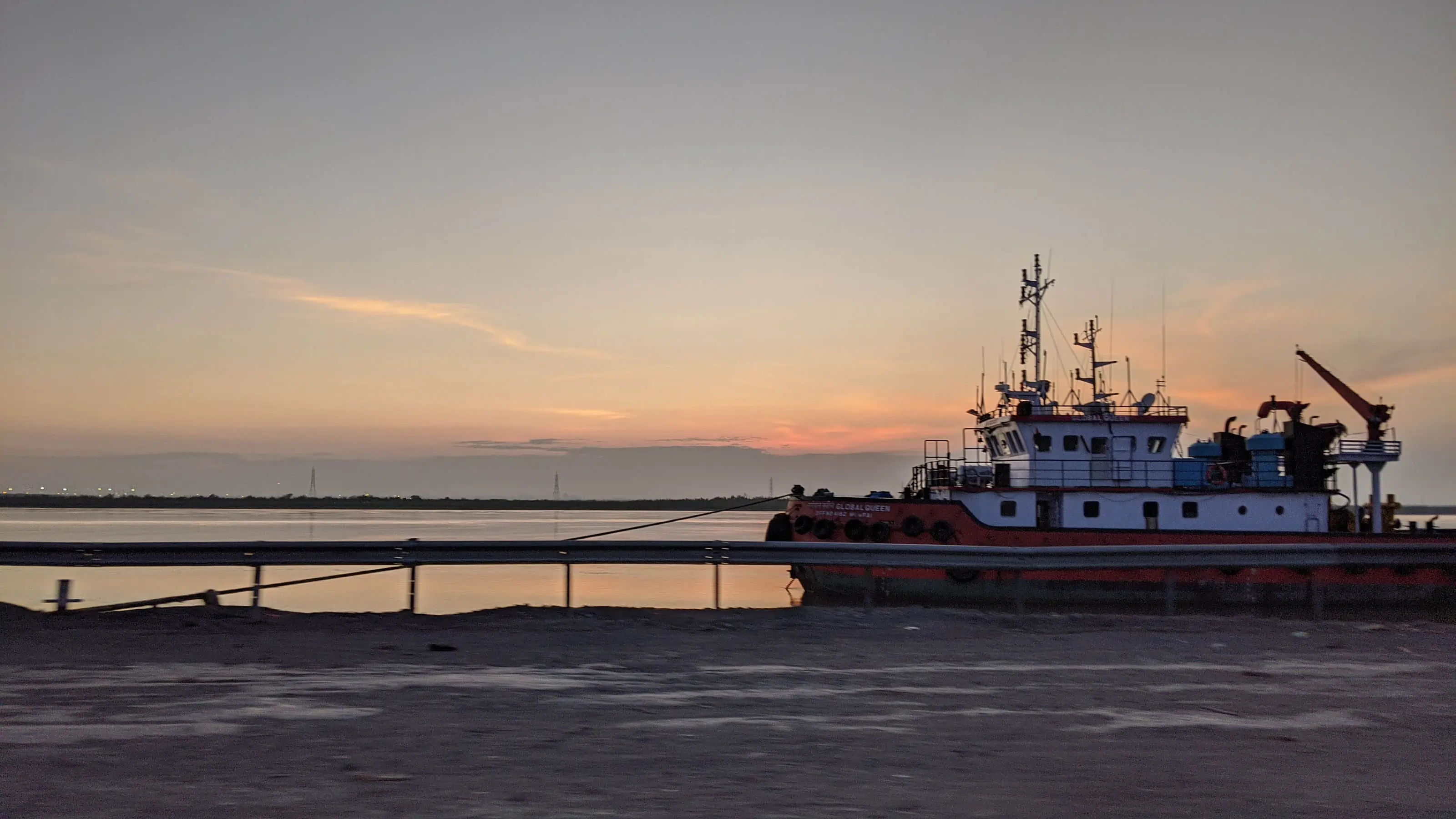 Ship sailing at dusk in Surat